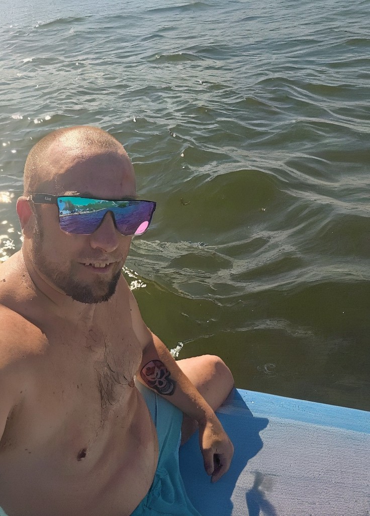 Sitting on paddleboard Jay 